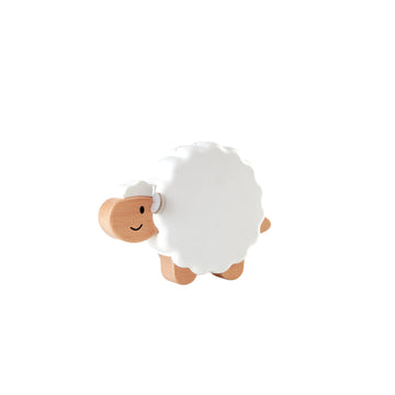 A white, smiling sheep nightlight designed for children, with a soft glow emitting from its body.