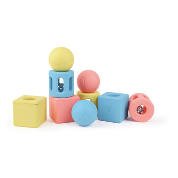 A set of colorful geometric-shaped rice toys designed for babies, including cubes and spheres.