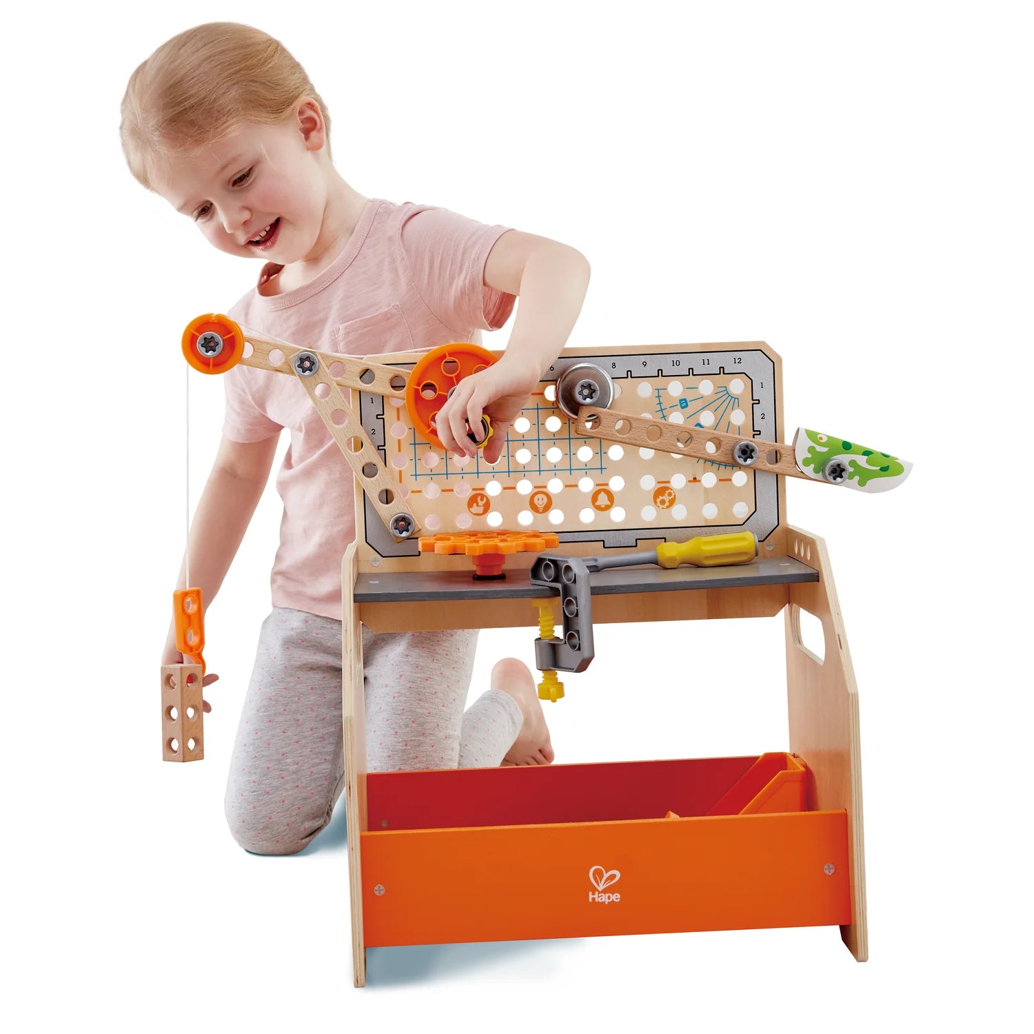 Child playing with a toy construction set on a white background