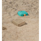 Toy sandcastle mold on a sandy surface