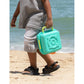 Child holding a teal toy camera on a beach