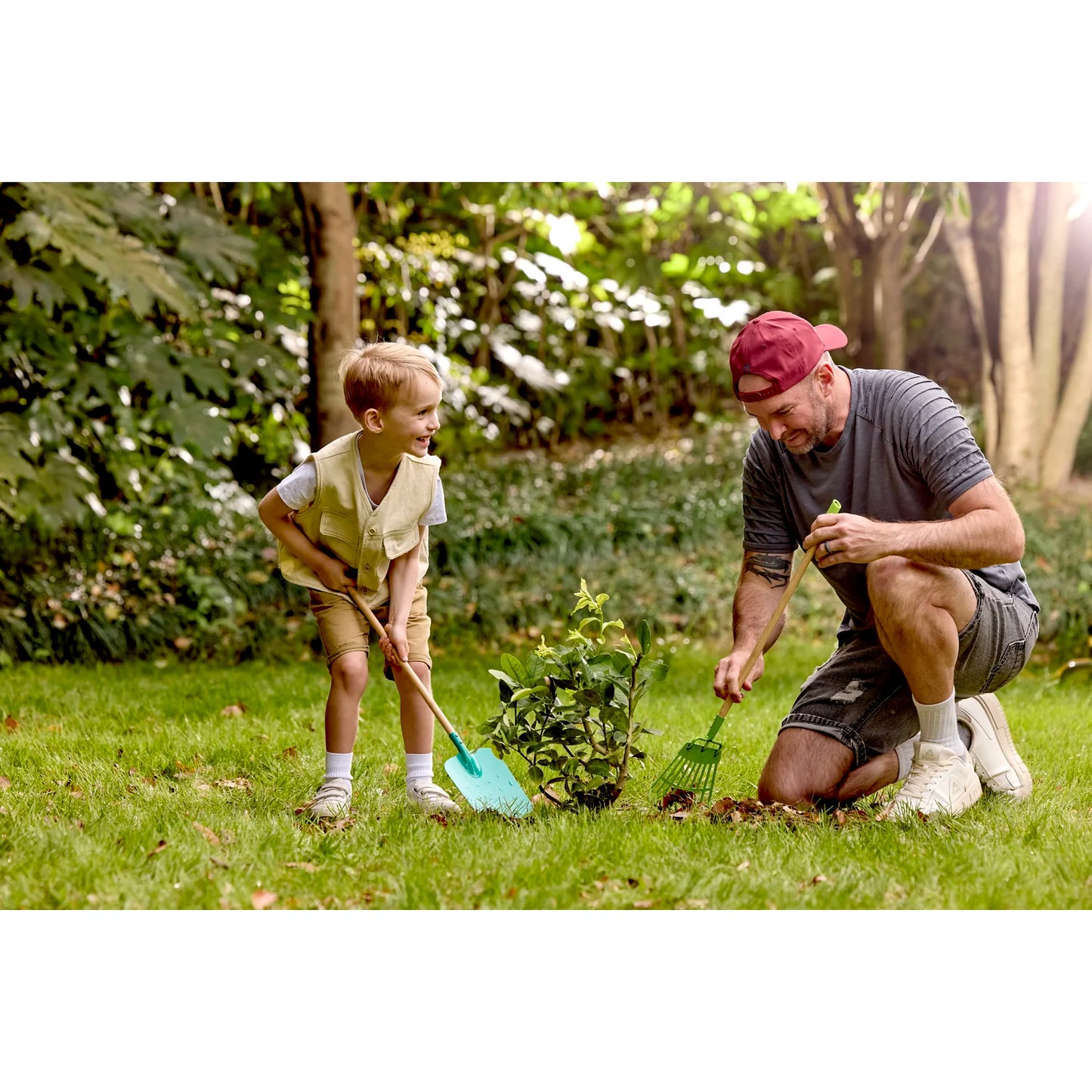 Man and child gardening together in a lush green garden