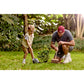 Man and child gardening together in a park with trees and grass in the background
