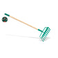 Green garden rake with wooden handle on a white background