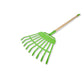 Green garden rake with wooden handle on a white background