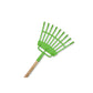 Green garden rake with wooden handle on a white background