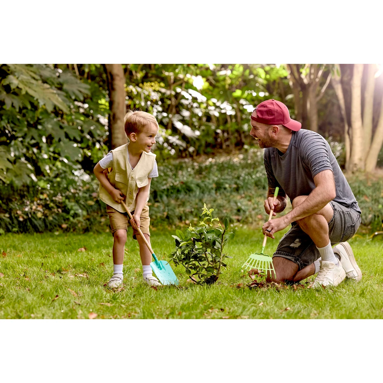 Man and child gardening together in a park