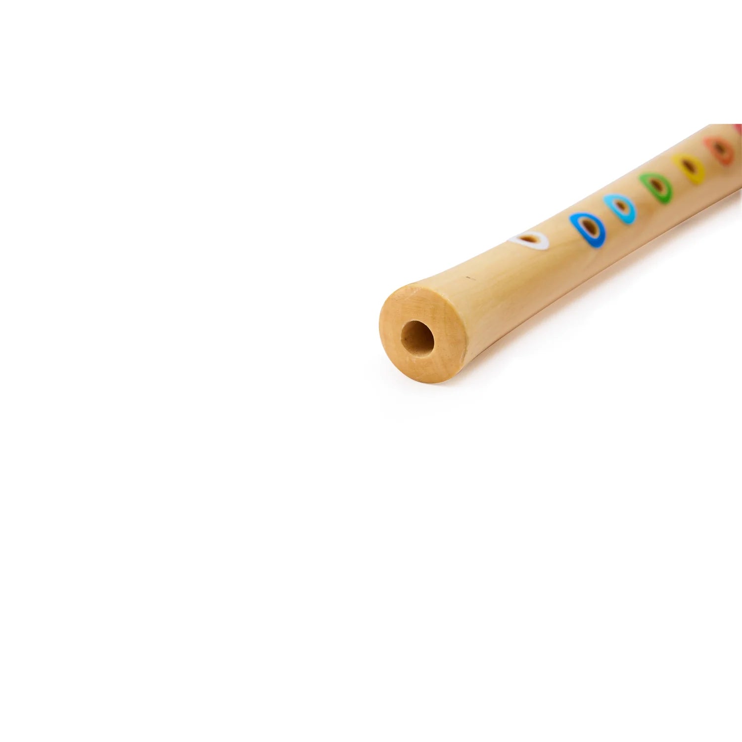 Wooden toy flute with colorful holes on a white background