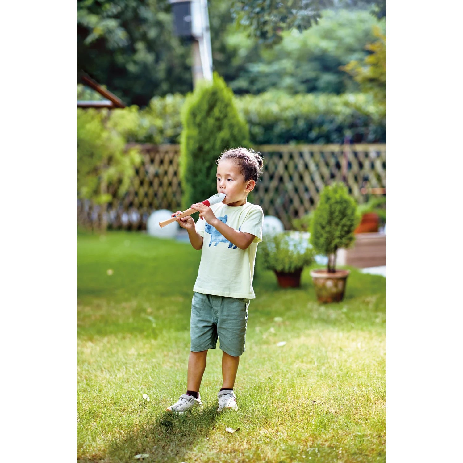 Child playing with a wooden toy in a garden