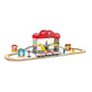 Toy train set with a station building on a white background