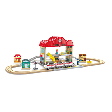 Toy train set with a station building on a white background