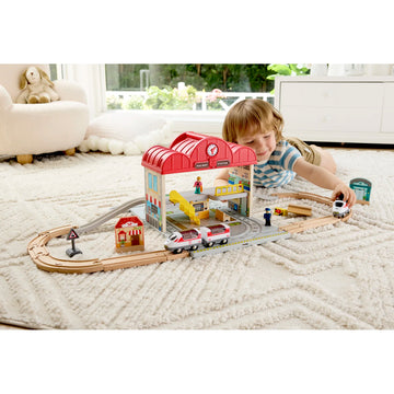 Child playing with a toy train set on a living room floor.