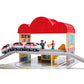 Toy train set with a red roofed building and toy figures on a white background