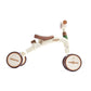 Children's balance bike with brown seat and wheels on a white background