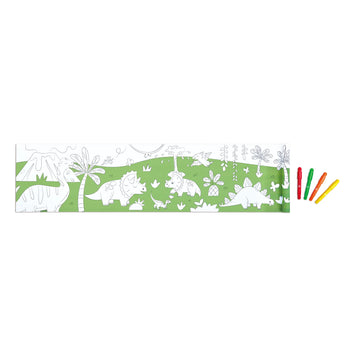 Coloring book with dinosaur illustrations on a green background, accompanied by colored pencils.