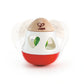 A red and white bell rattle with side cut-outs and a wooden ring on top, designed for babies.