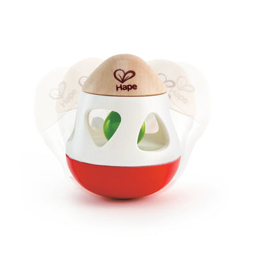 A red and white bell rattle with side cut-outs and a wooden ring on top, designed for babies.
