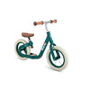 A green Hape balance bike with cork handle grips and a wooden seat, designed for young children.