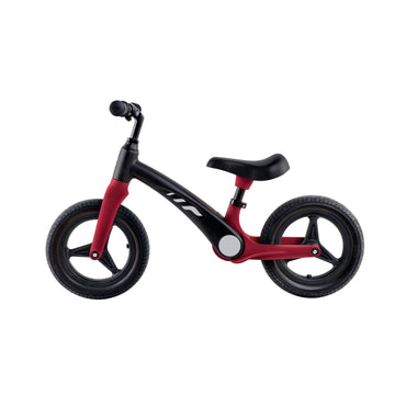 A red and black balance bike with adjustable handlebars and a saddle, suitable for young children.