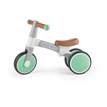 A green and white Hape balance bike with anti-slip handles and non-slip tires designed for toddlers.