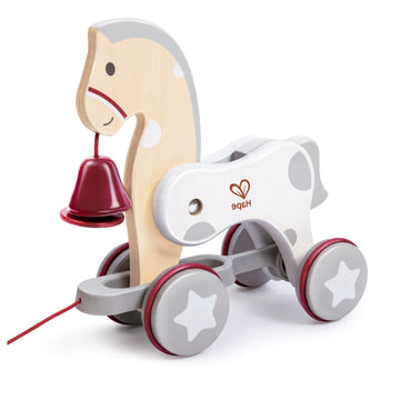 A wooden pull-along toy in the shape of a pony with non-toxic finishes, featuring rubber wheels and a bell on the pony's neck.