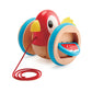 A colorful wooden pull-along toy shaped like a bird with wings and a tail, on a red string.