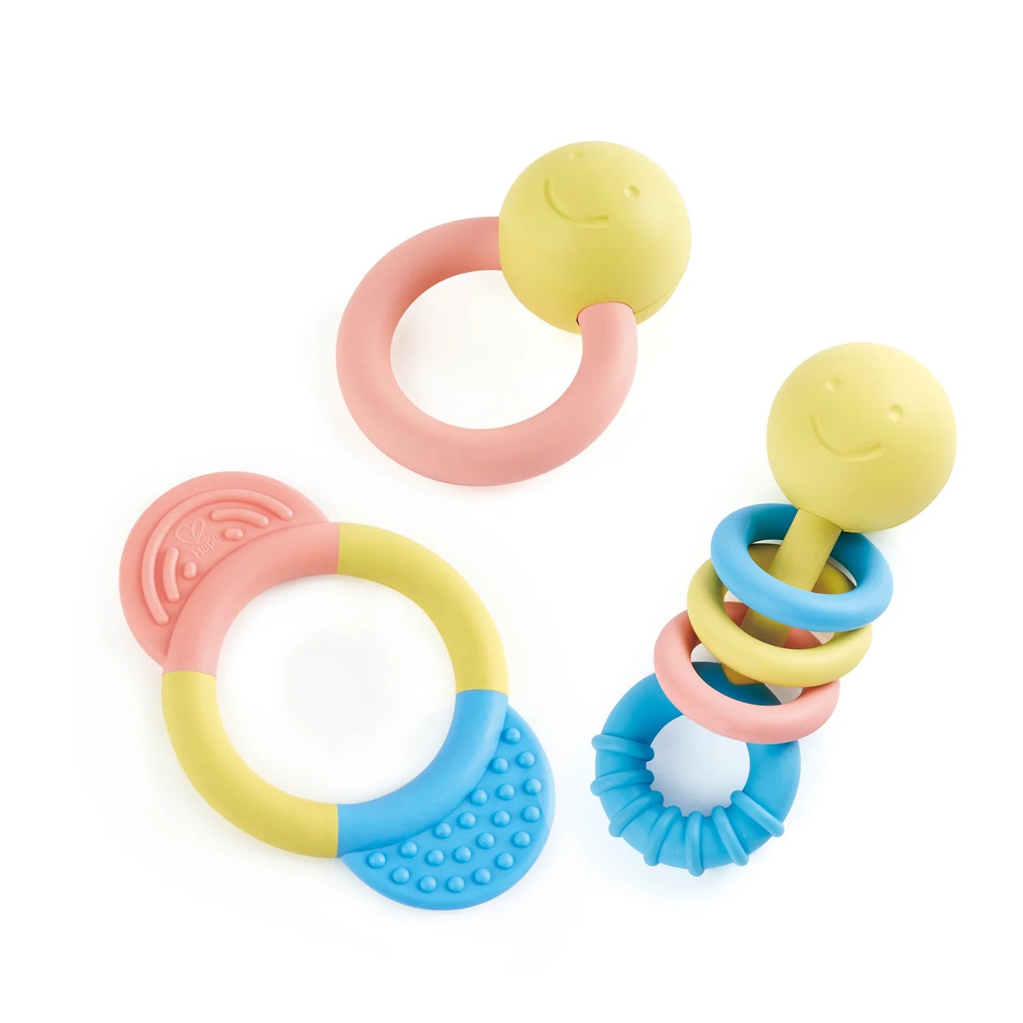 A set of colorful baby rattle and teether toys, including rings and shapes in soft colors, made from a rice-based material.