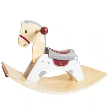 A wooden rocking horse with a cushioned seat and red anti-slip handles on a curved rock base, set against a white background.