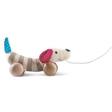 A soft fabric dog toy on wheels with wooden components, featuring rotatable ears and a pull-along string.
