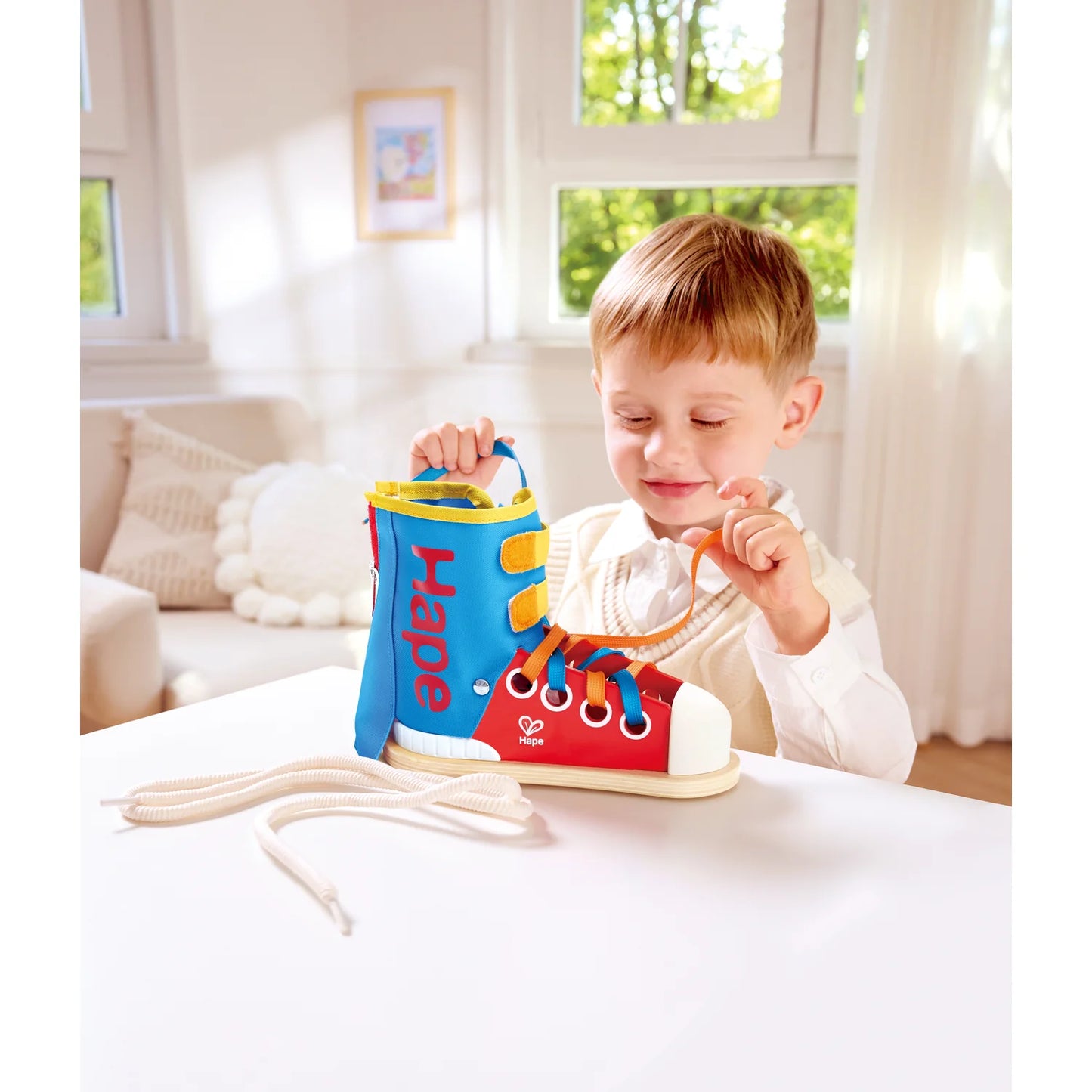 Child playing with a colorful toy shoe in a bright room
