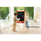 Two children playing with a colorful easel in a bright room with large windows.