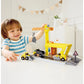 Child playing with a toy construction set on a white surface