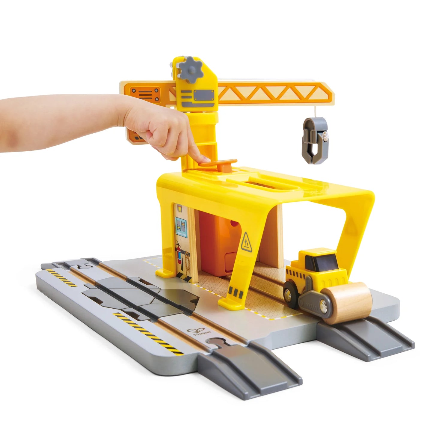 Toy construction set with crane and tracks on a white background