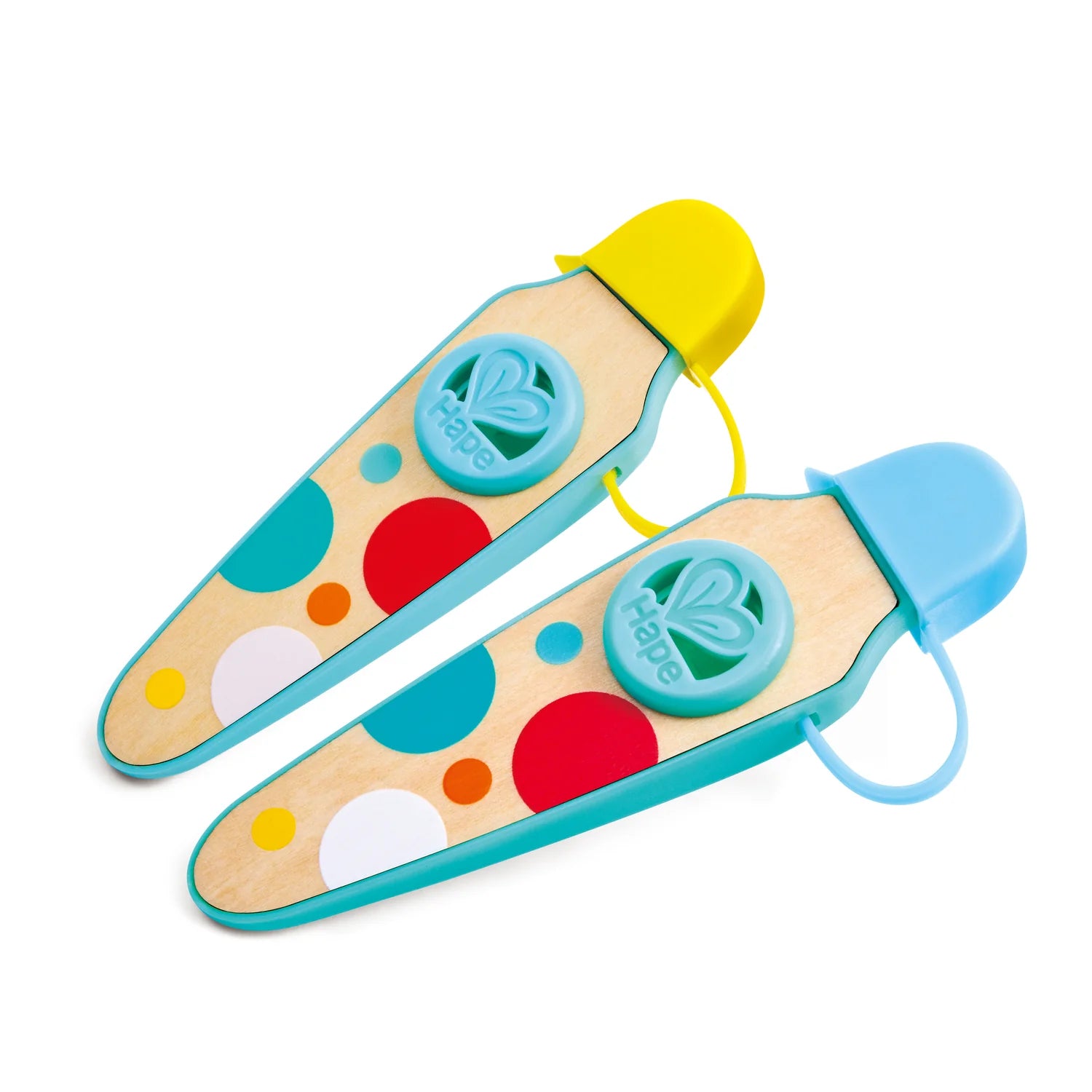 Colorful toy spatulas with polka dot design on a white background