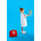 Child in a white coat holding a toy stethoscope and first aid kit on a blue background