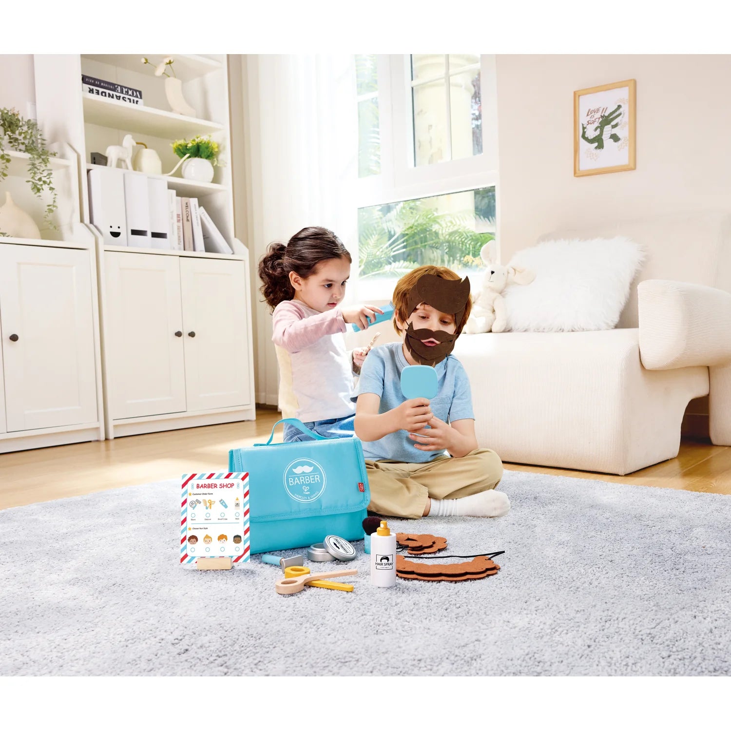 Two children playing with a toy kitchen set in a living room.