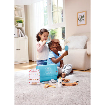 Two children playing with a hair styling set on a carpeted floor.