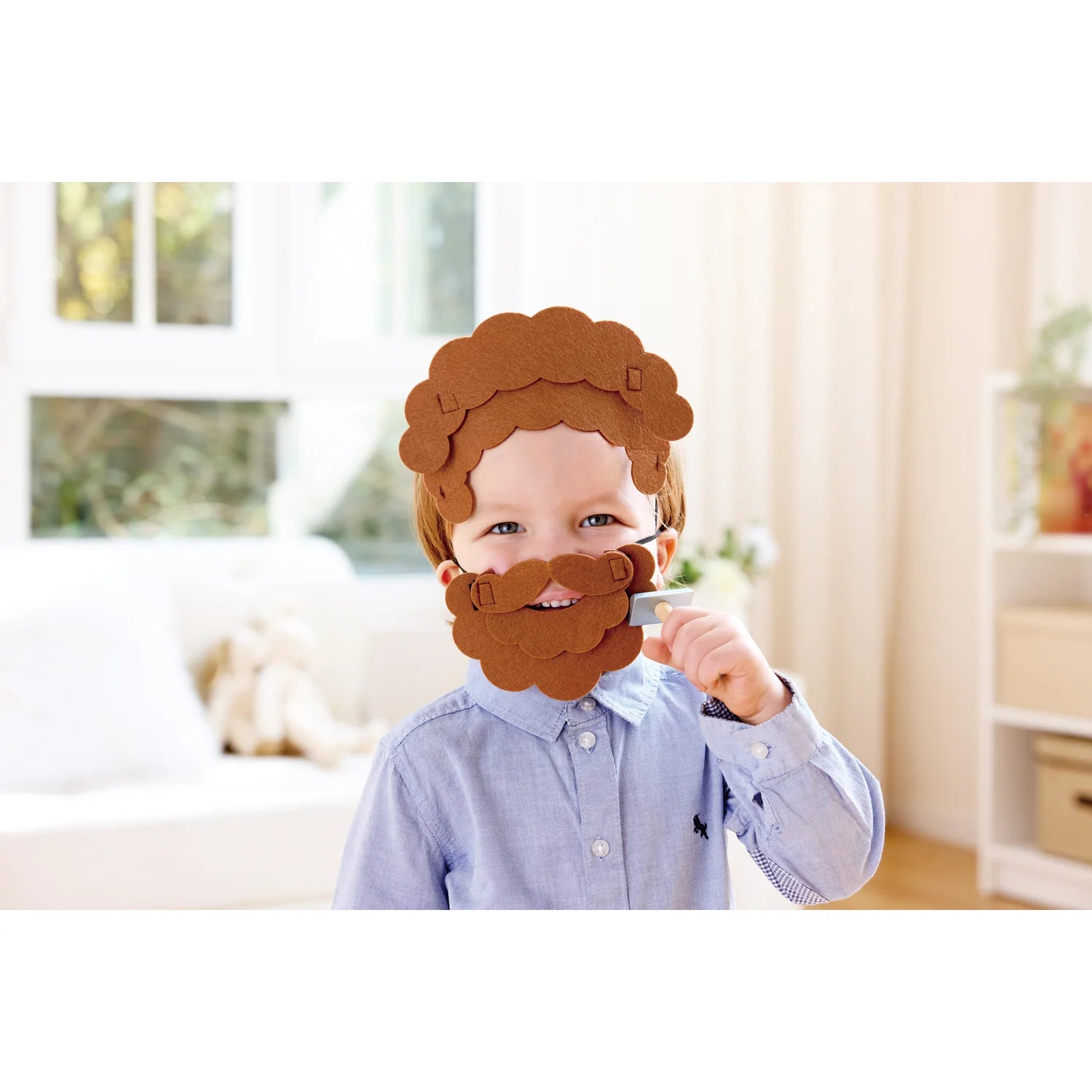 Child wearing a brown beard mask indoors