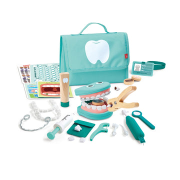 Toy dental set with tools and a teal bag on a white background