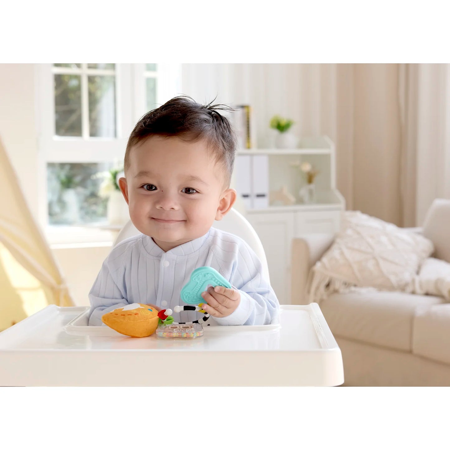 Child sitting at a table with a toy in a bright, home setting