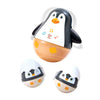 Wooden penguin toy with music notes on a white background