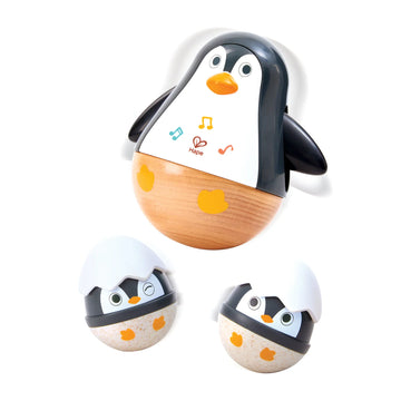 Wooden penguin toy with music notes on a white background